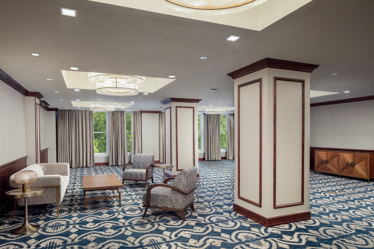 a room with a couch and chairs