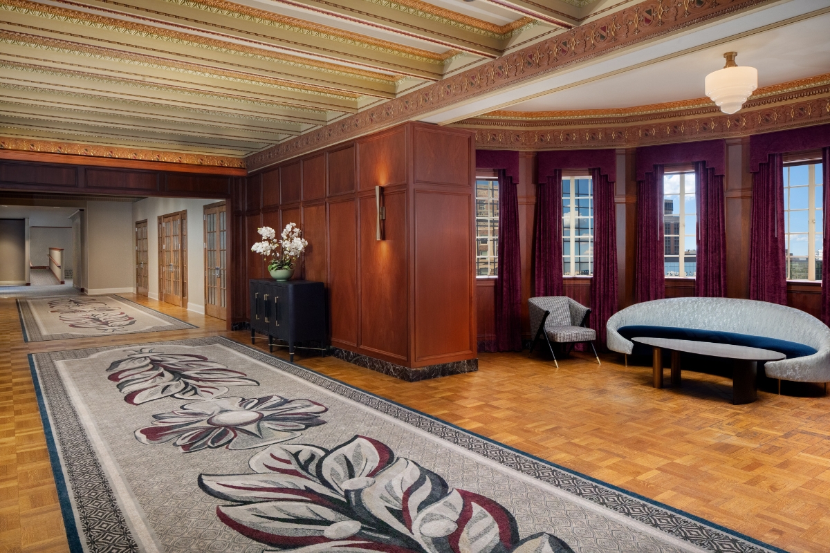 a room with a large rug and a couch