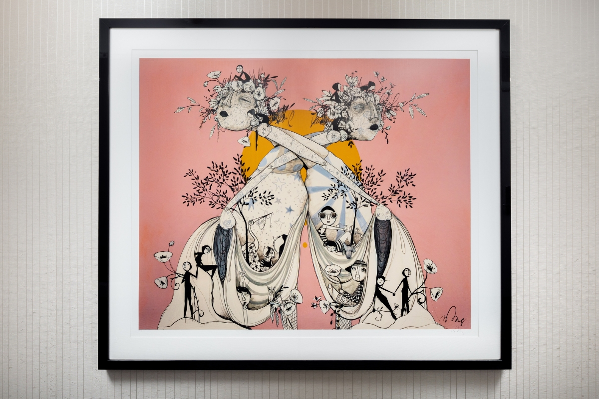 a framed picture of two women with flowers on it