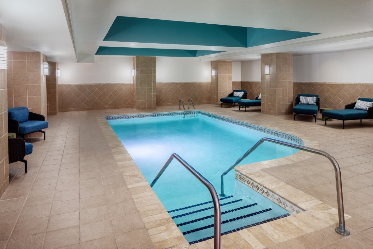 a indoor pool with a metal railing