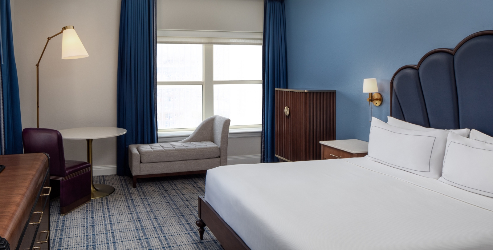 a bedroom with a bed and a chair