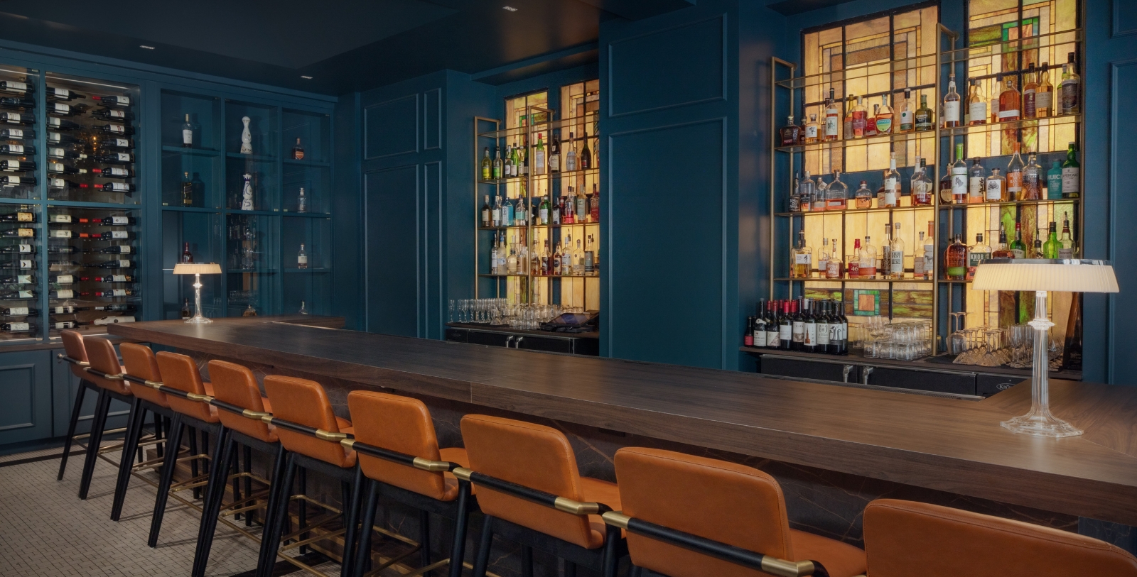 a bar with a long table and chairs