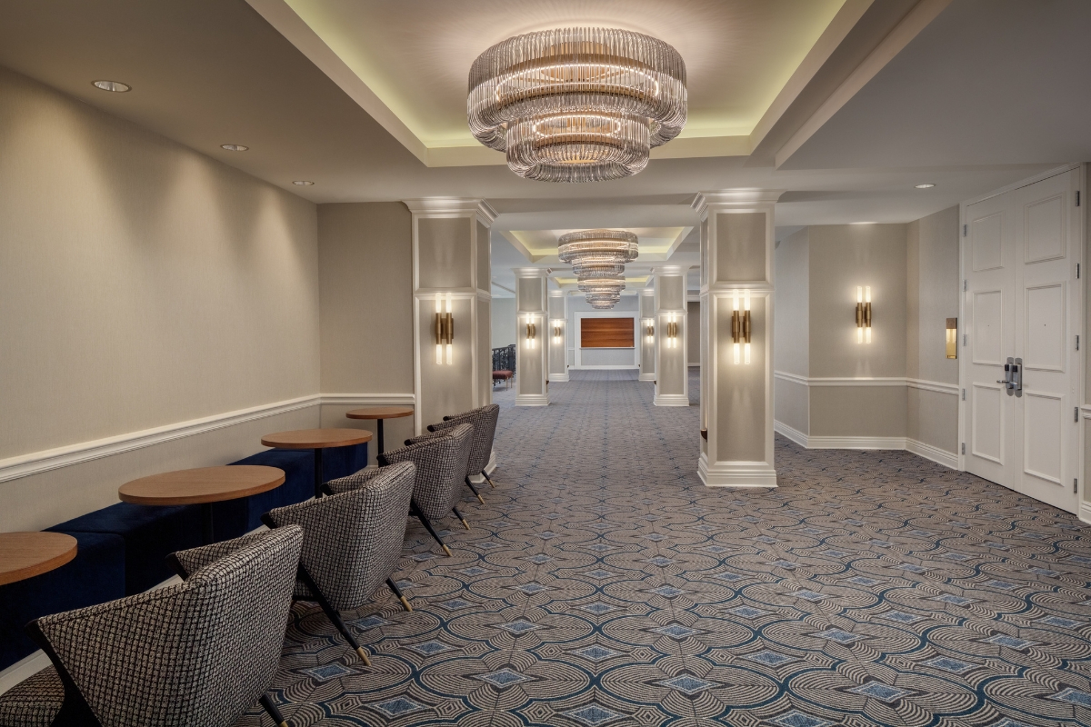 a room with chairs and chandeliers