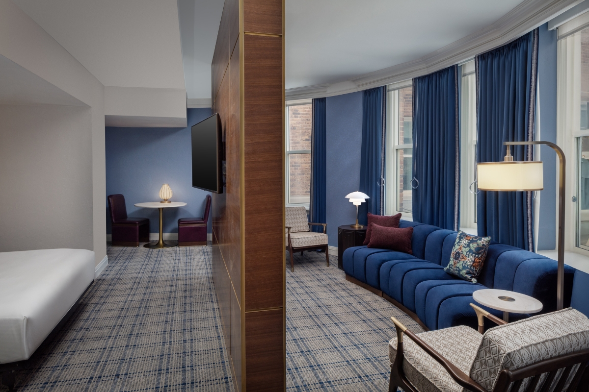 a room with blue couches and a tv