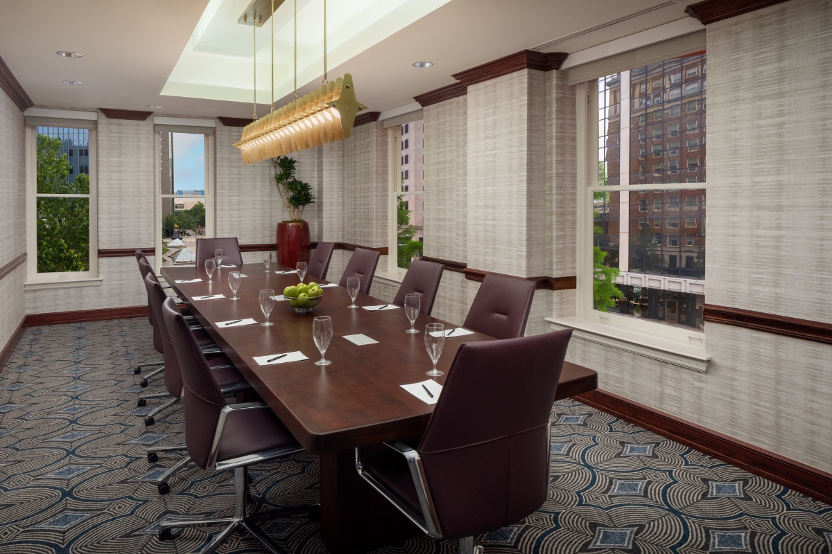 a conference room with a long table and chairs