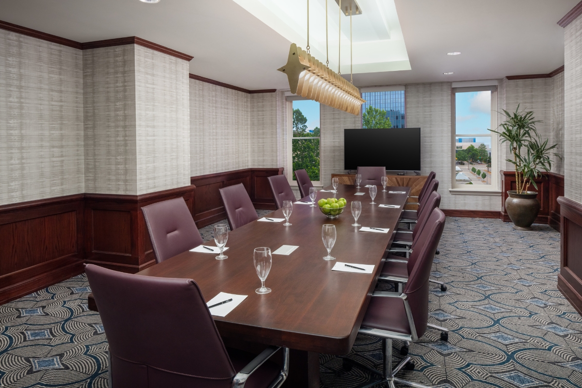 a conference room with a table and chairs