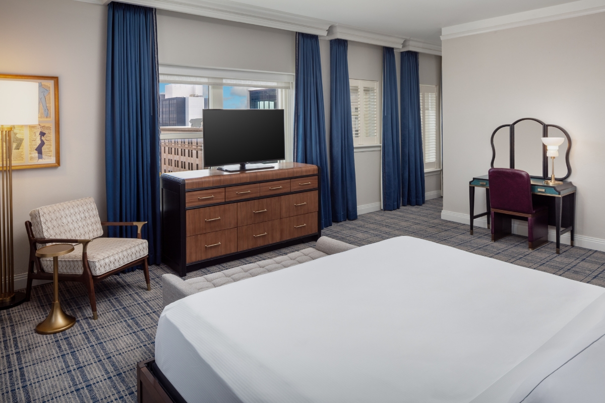 a room with a tv and a dresser