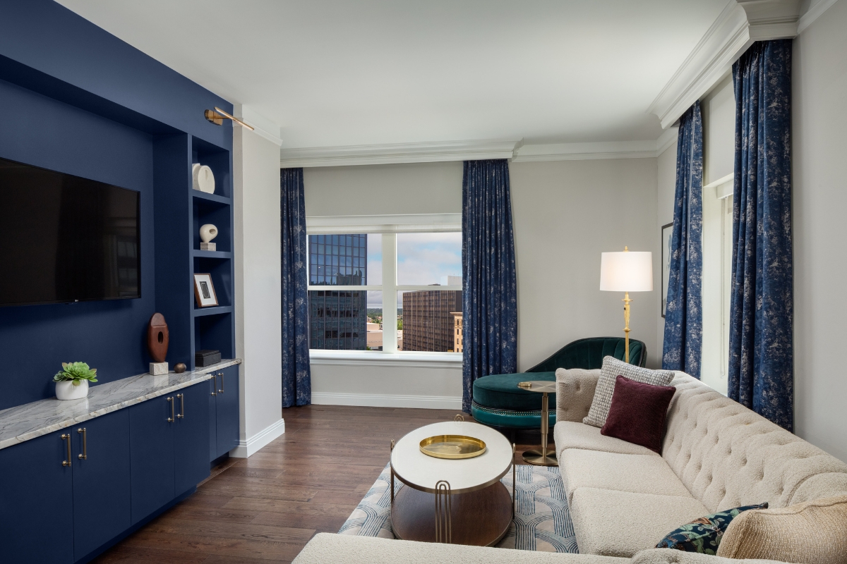 a living room with blue curtains and a couch