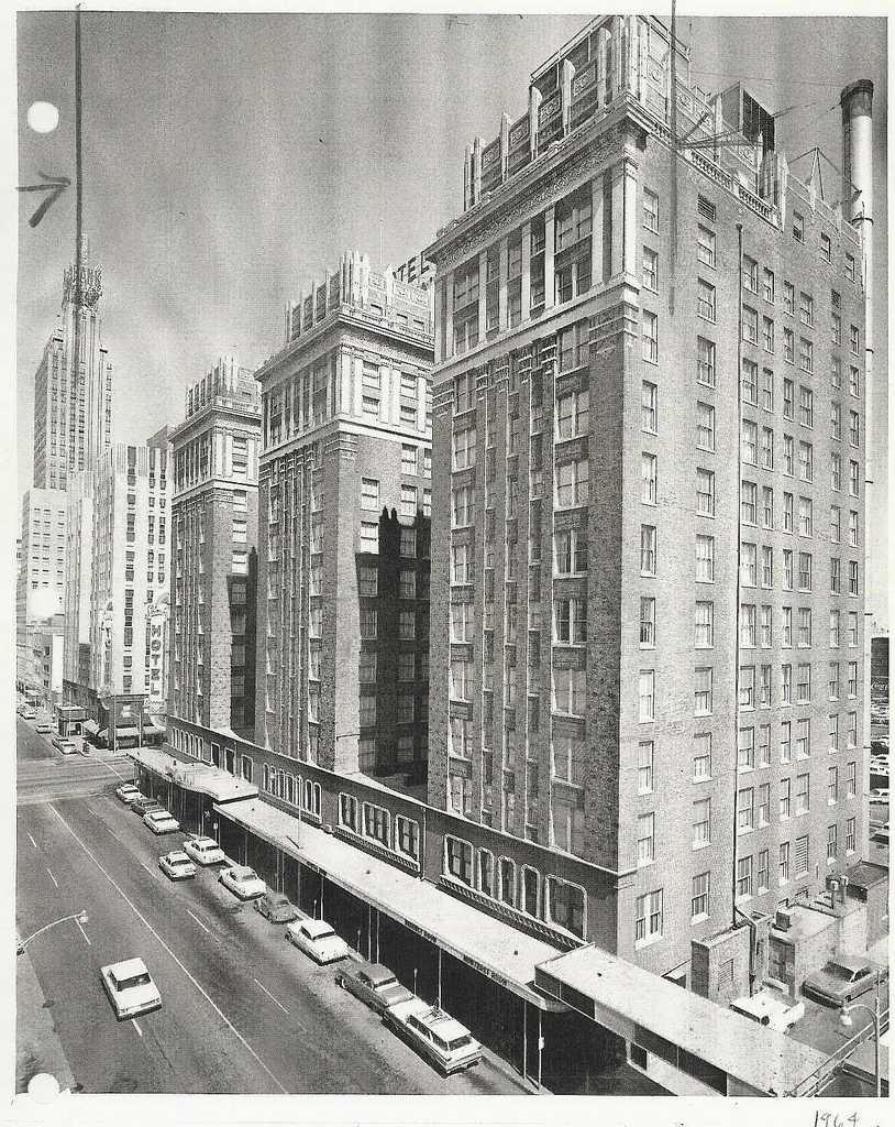 a tall building with cars parked on the side