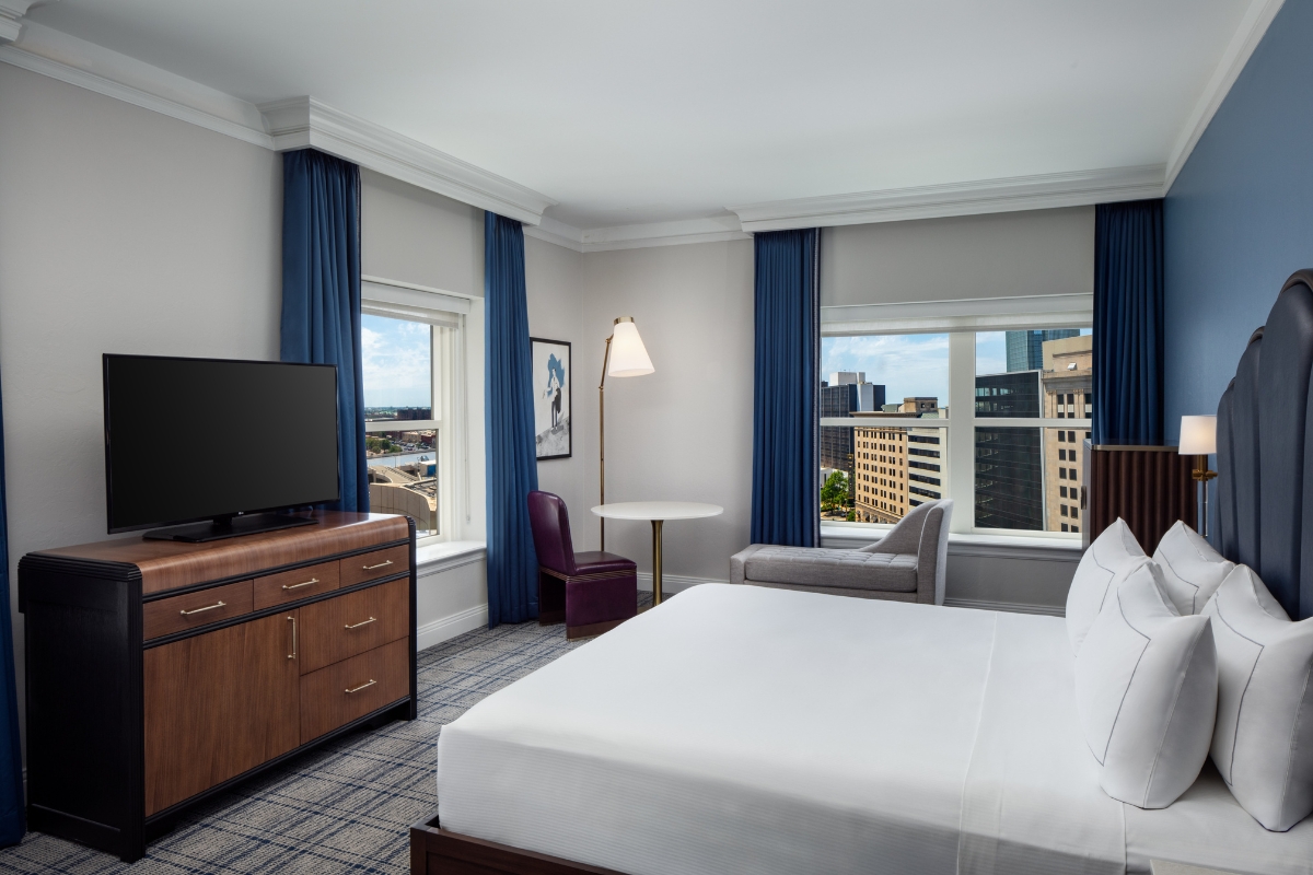 a room with a bed and a television