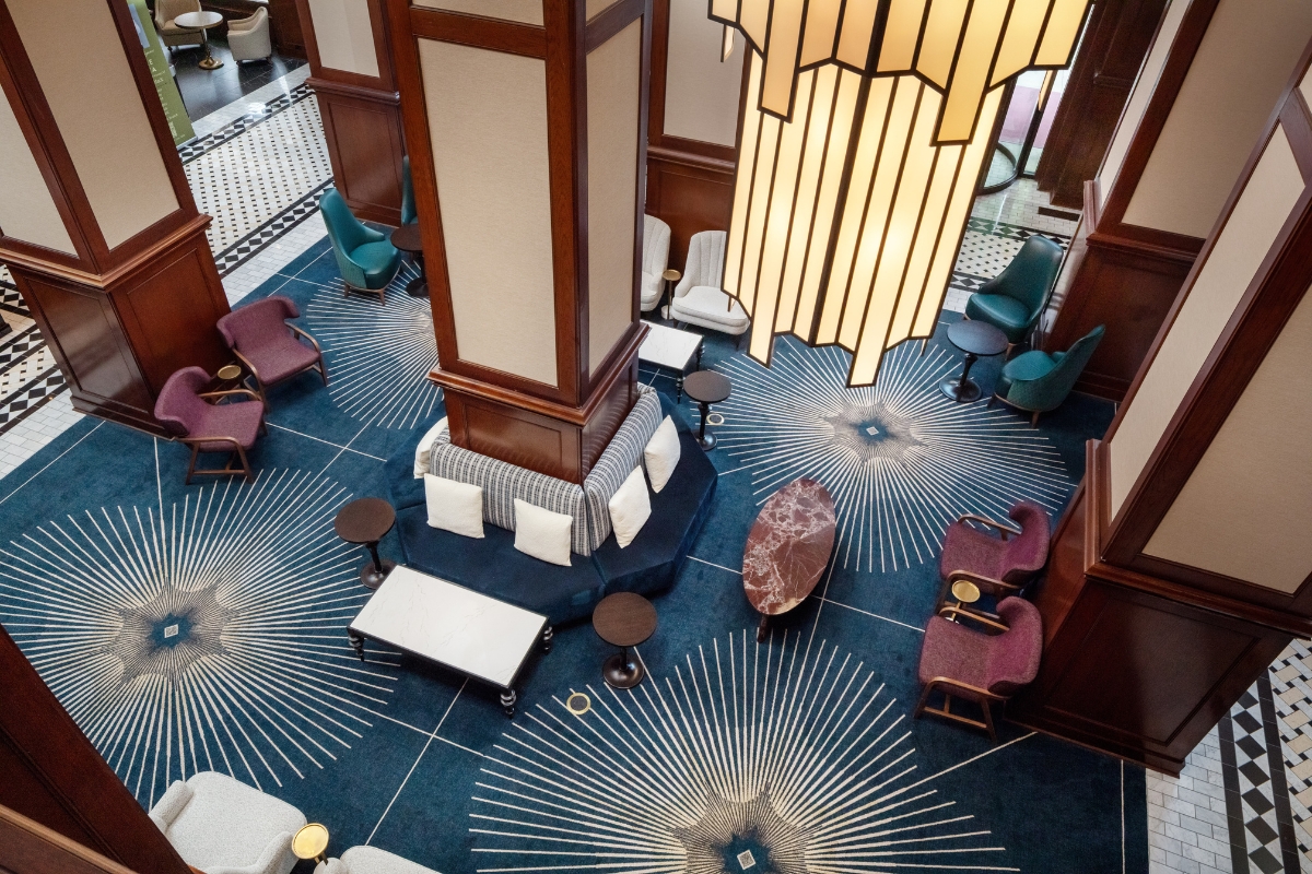 a room with a tall pillar and a large lamp