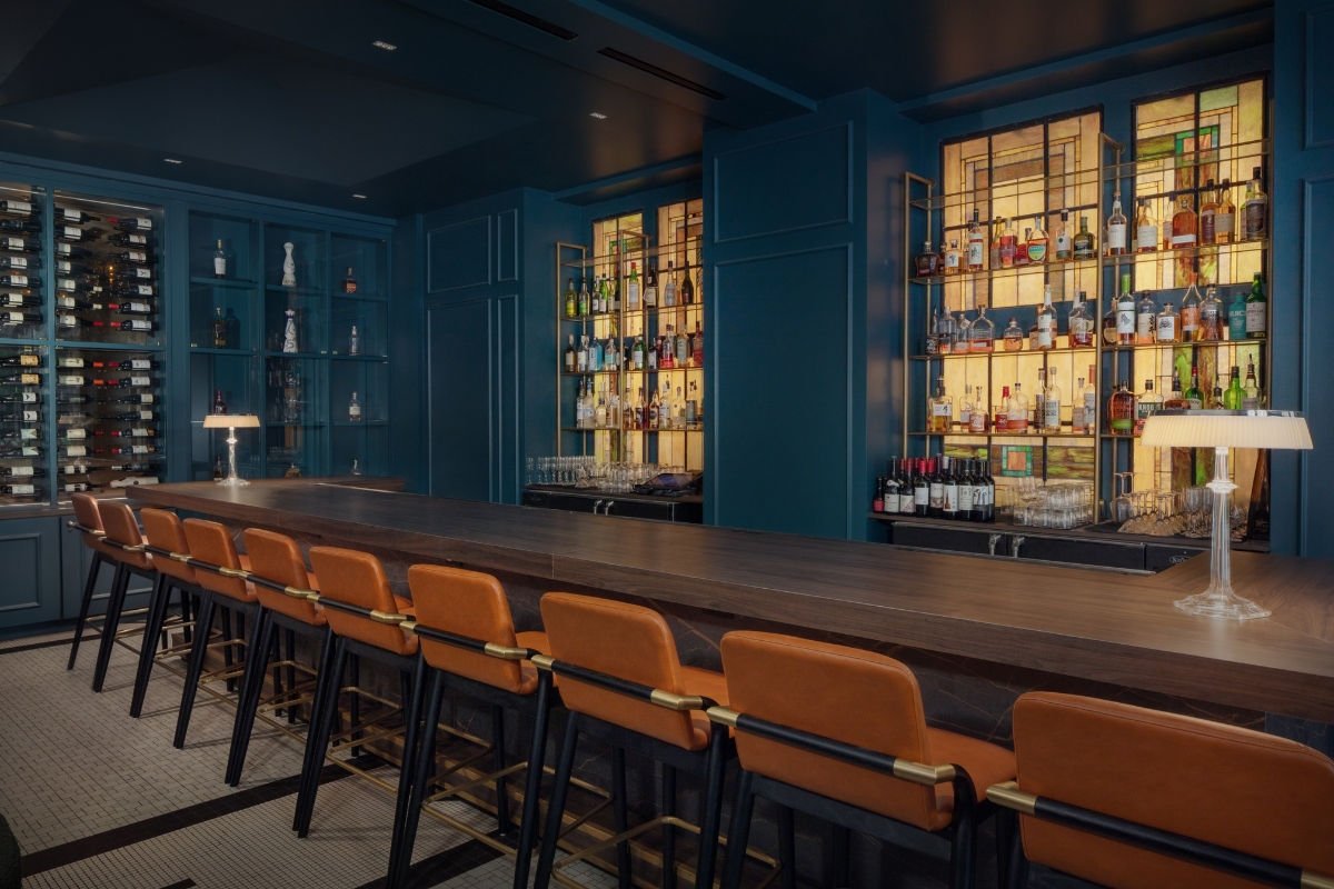 a bar with a long table and chairs