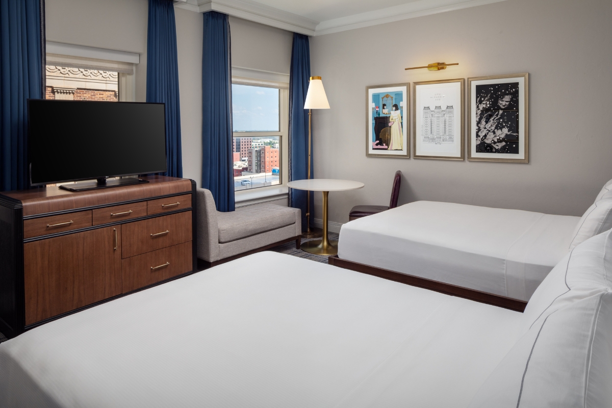 a room with two beds and a television