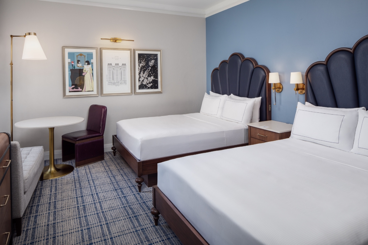 a room with two beds and a table