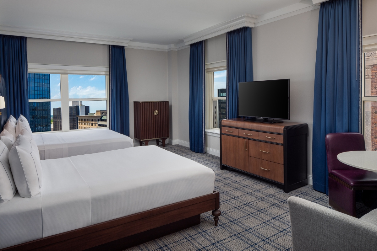 a room with two beds and a television