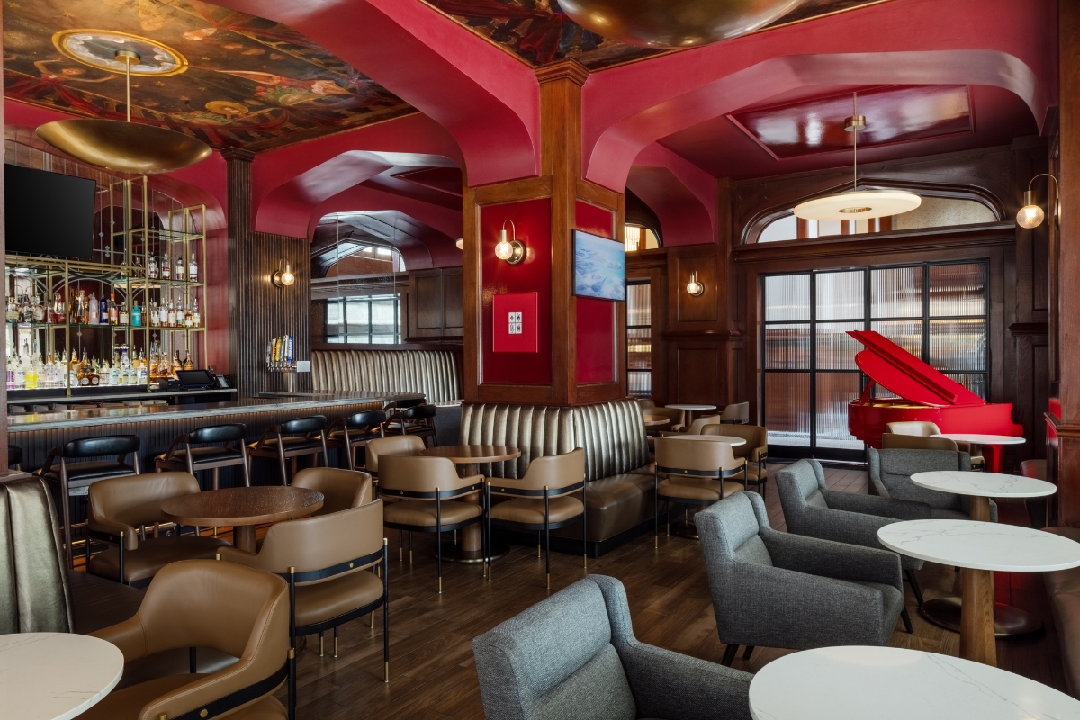 a room with red walls and tables and chairs