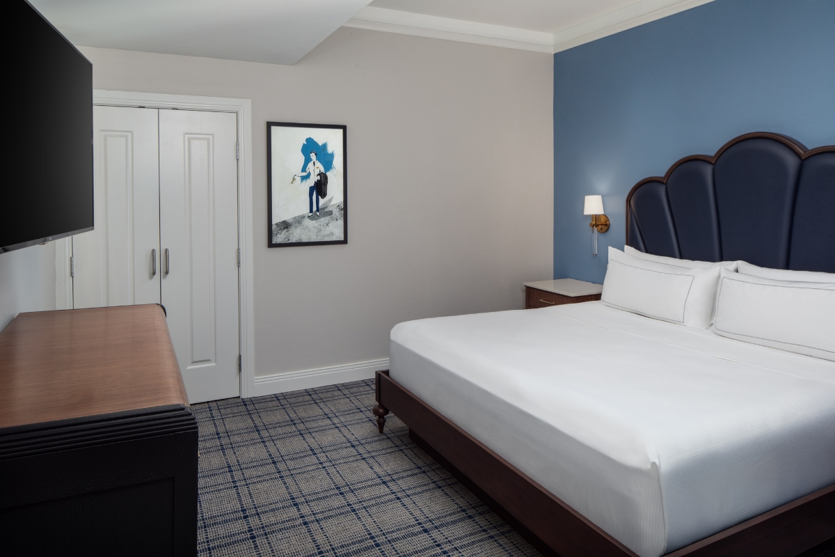 a room with a bed and a picture on the wall