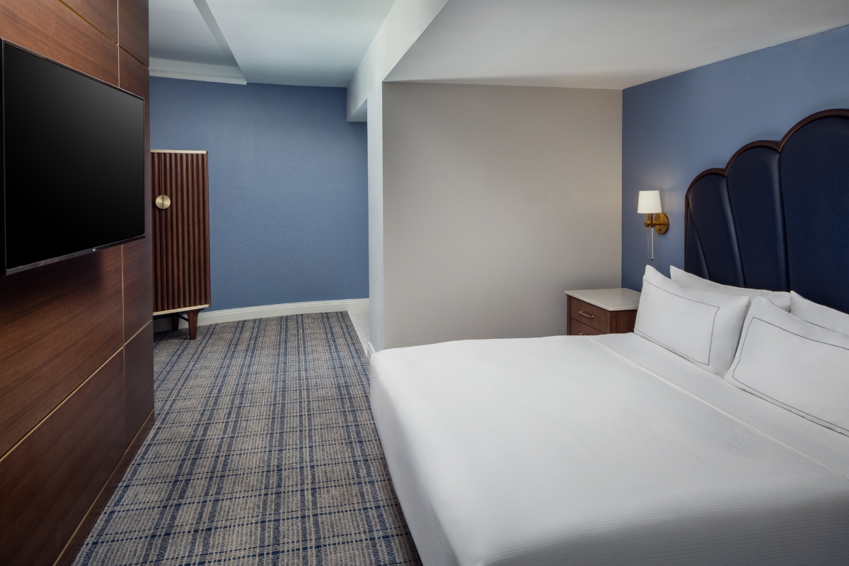 a room with a bed and a dresser