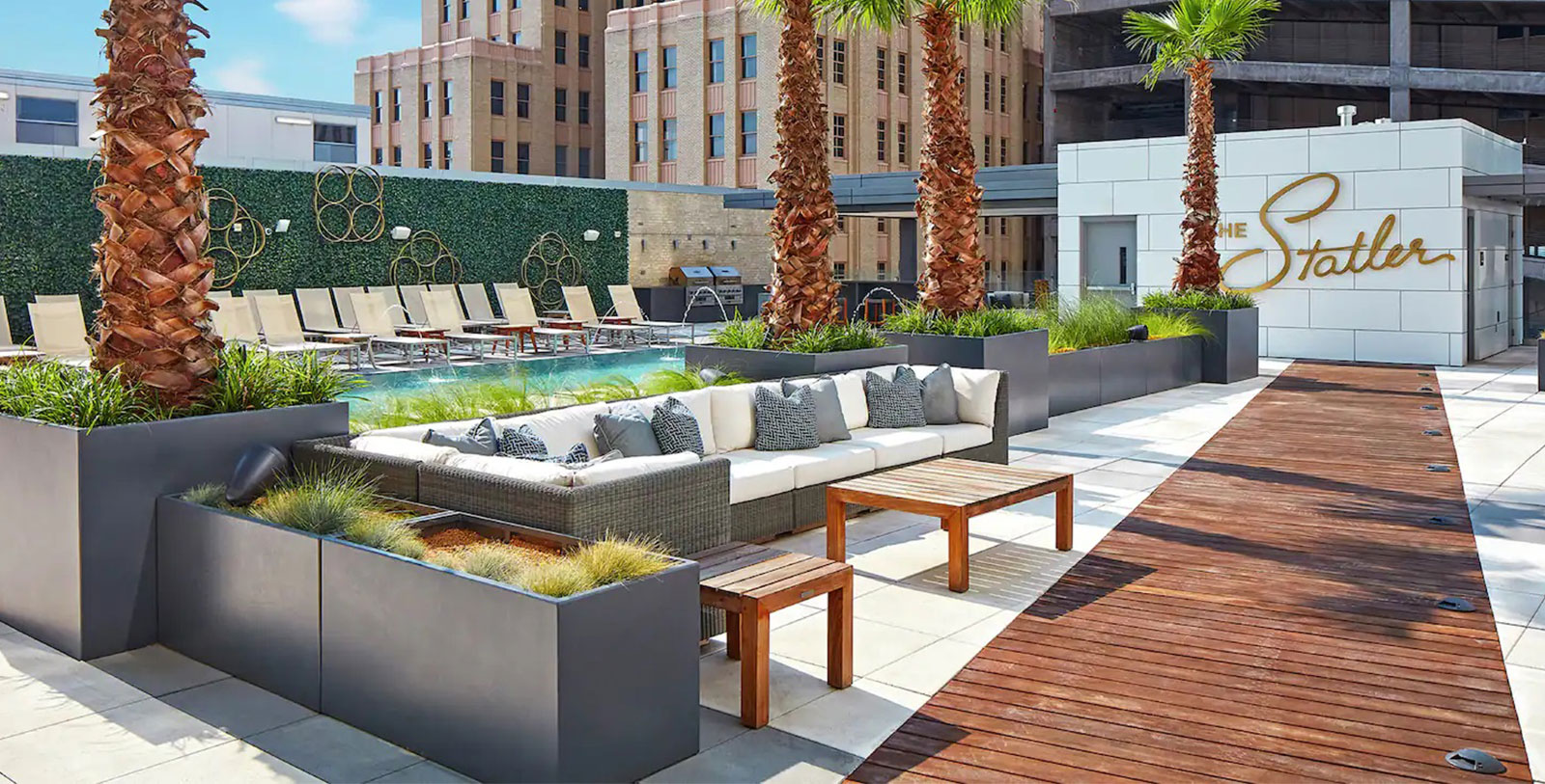 a pool with palm trees and a couch