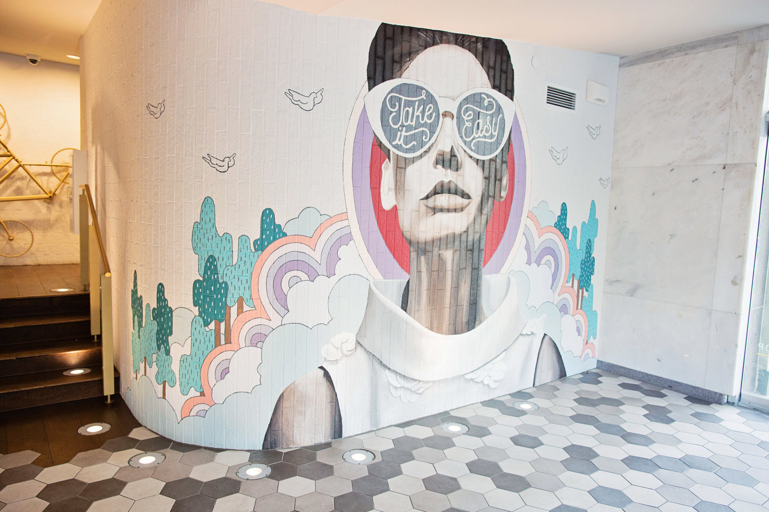 a mural of a woman with sunglasses on a wall