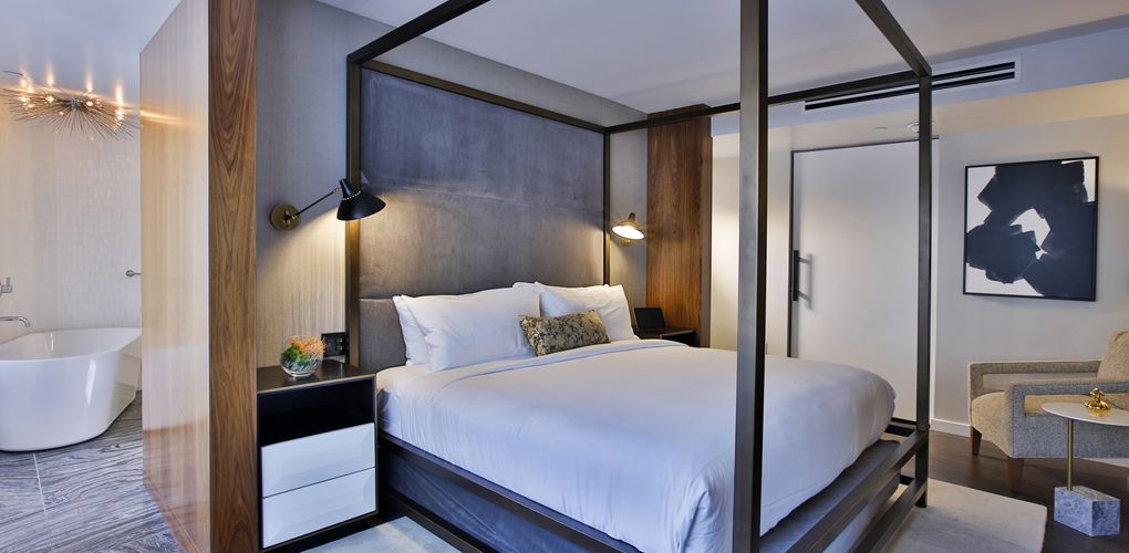 a bed with a four poster bed
