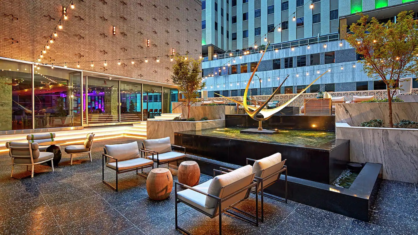 a courtyard with chairs and a fountain
