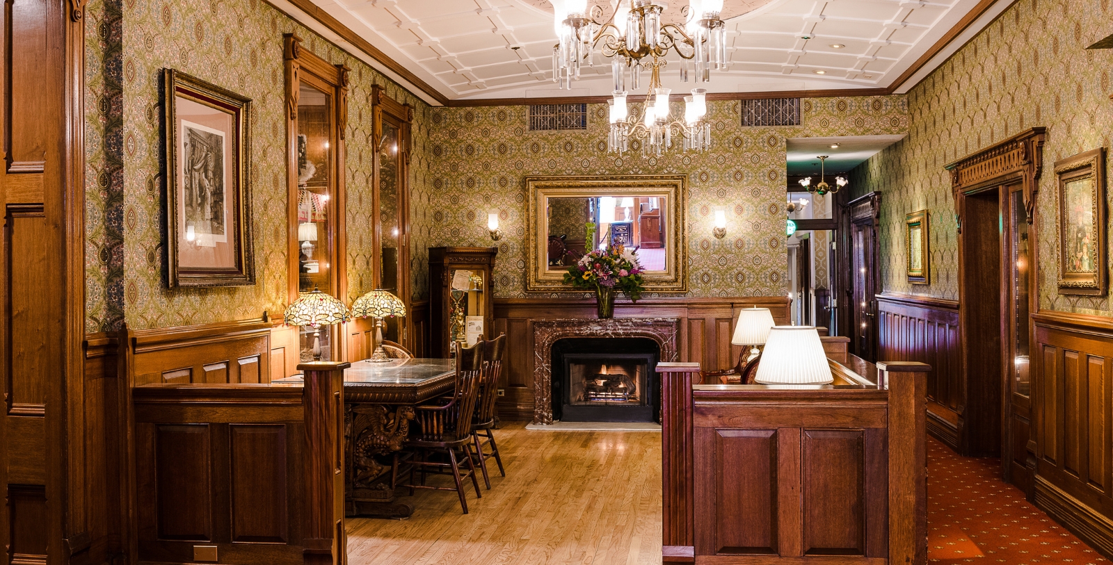 a room with a fireplace and chandelier