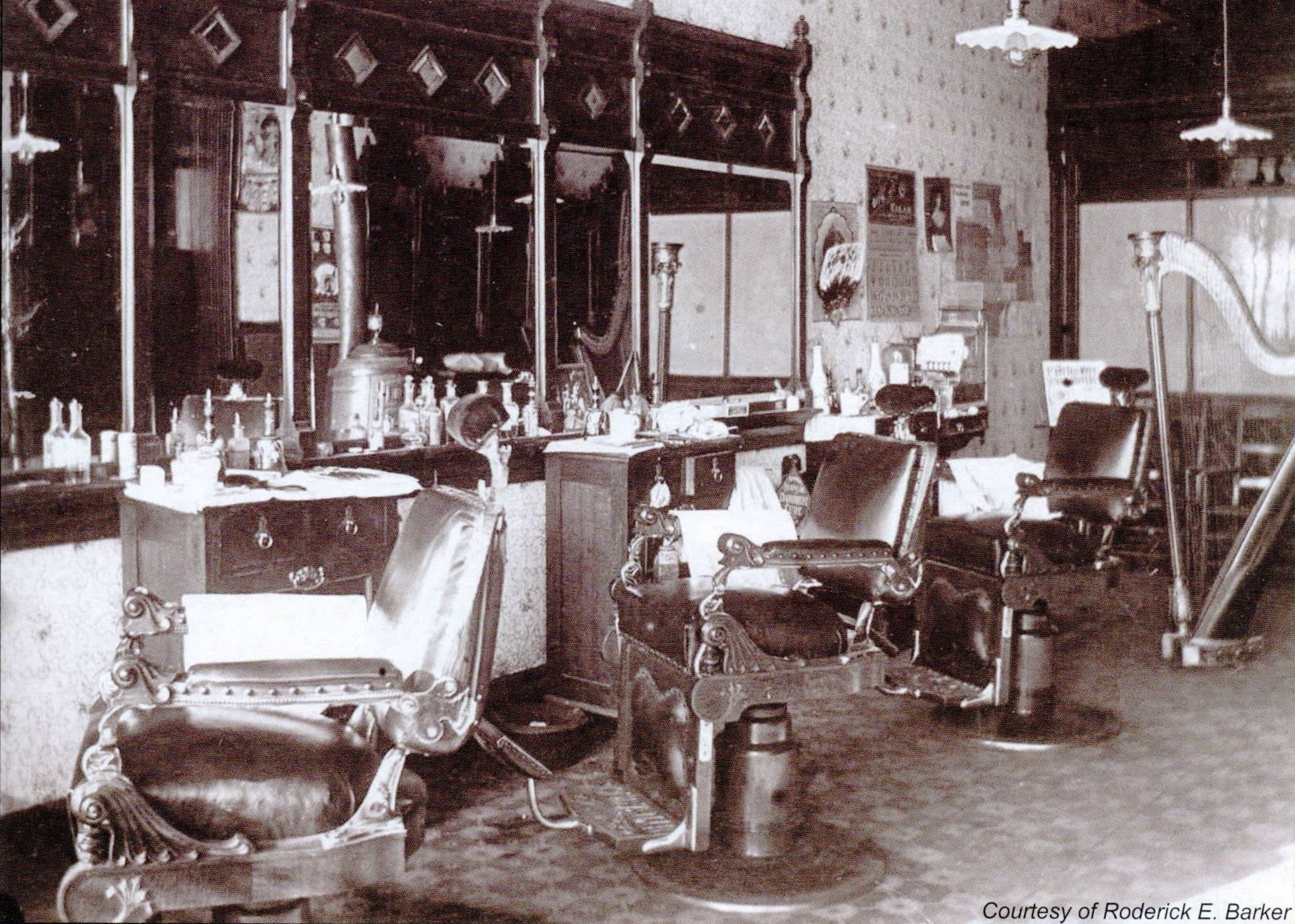 a barber shop with chairs and a mirror