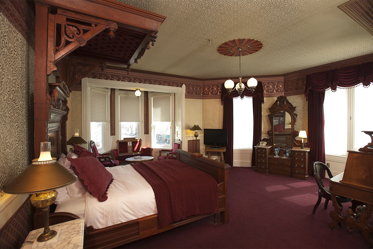 a bedroom with a bed and a mirror