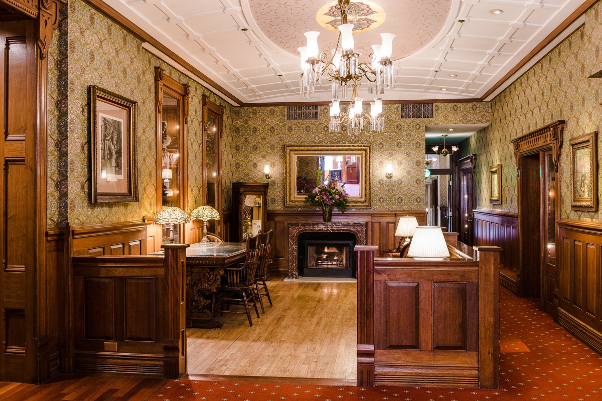 a room with a fireplace and chandelier