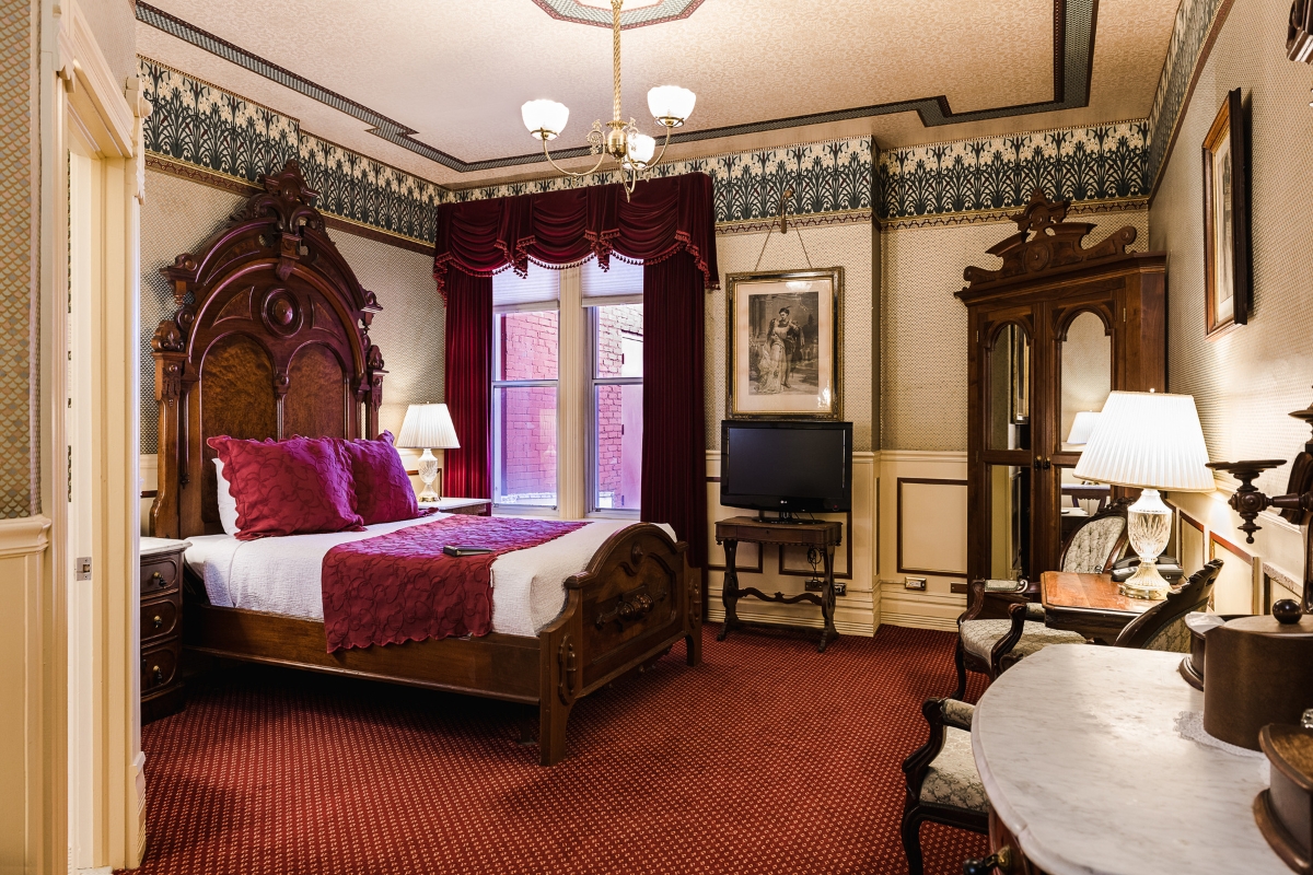 a bedroom with a bed and a television