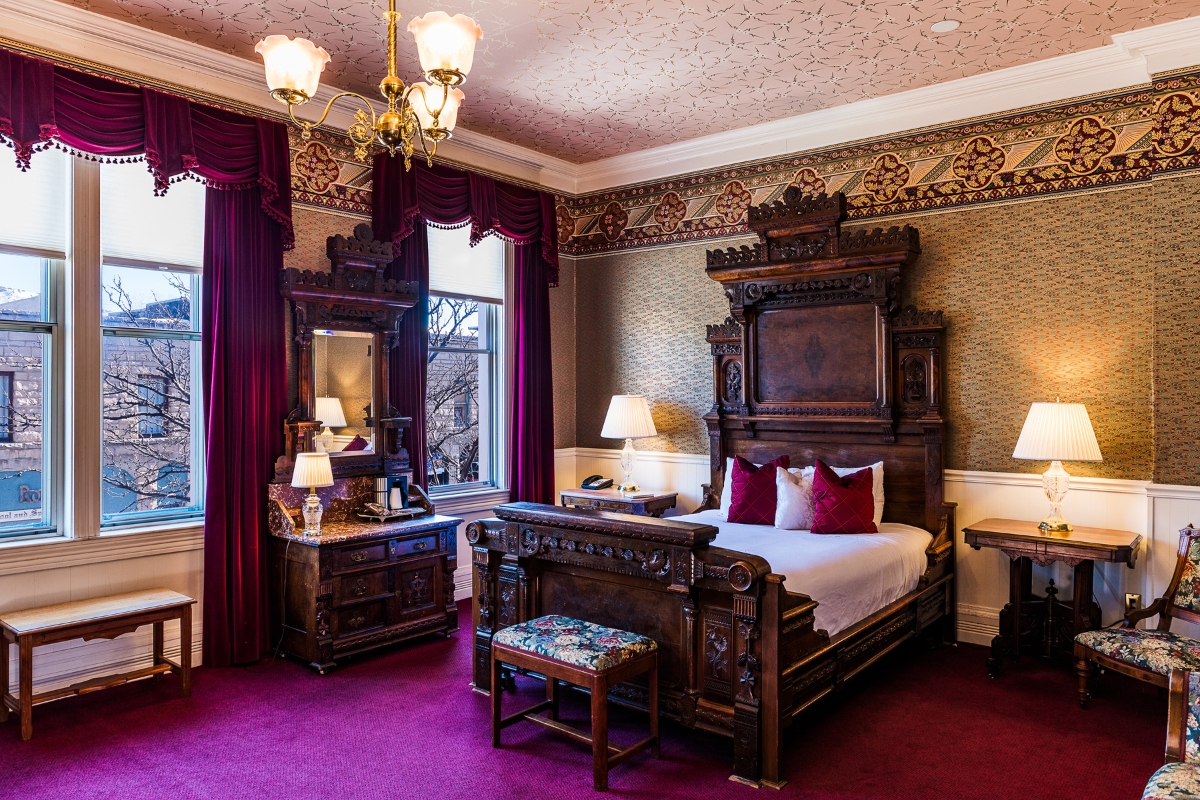 a bedroom with a bed and a mirror