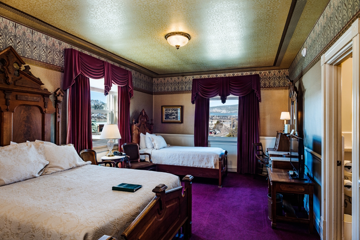 a room with two beds and a television
