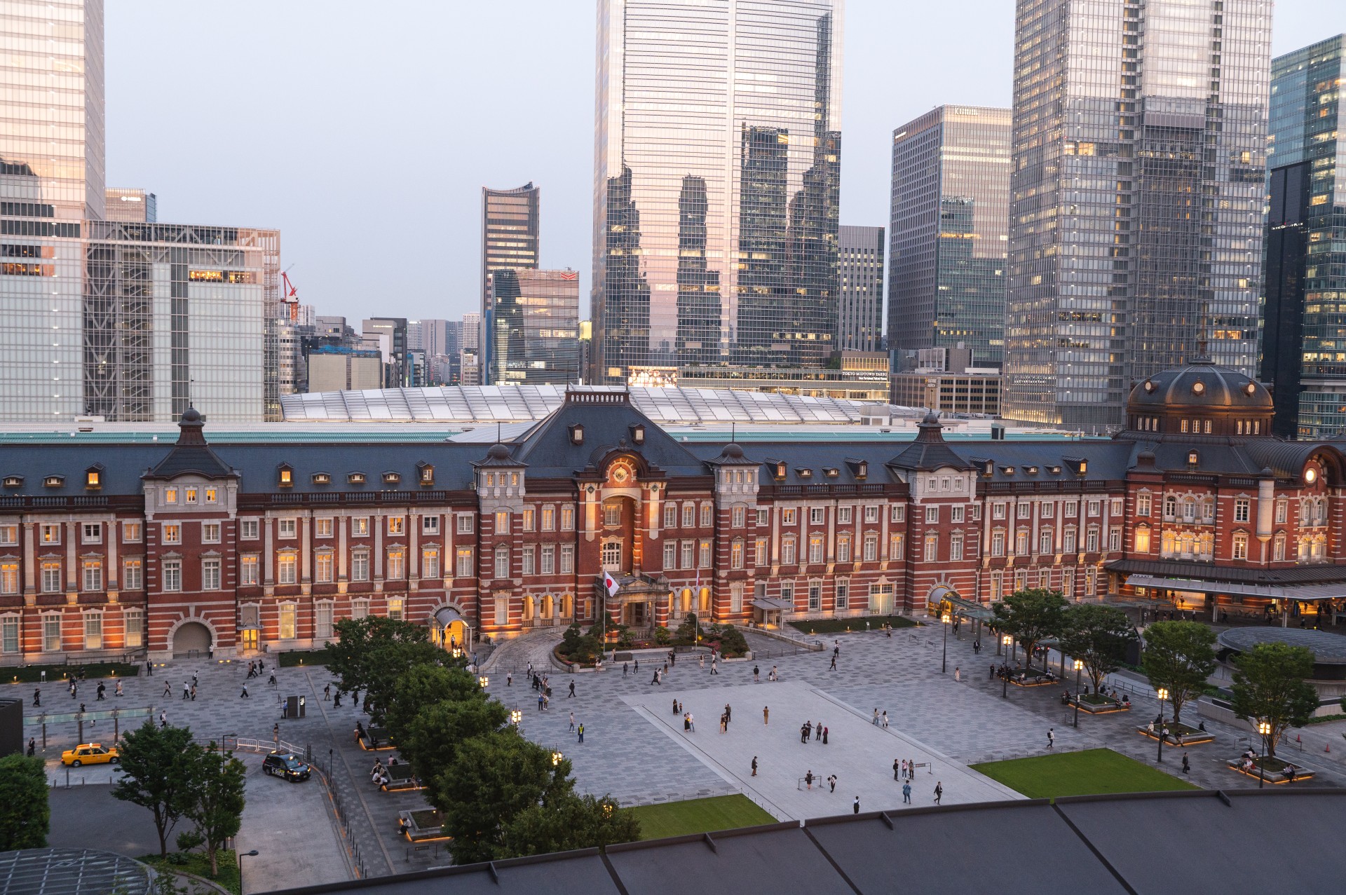 a large building with trees and people in front of it