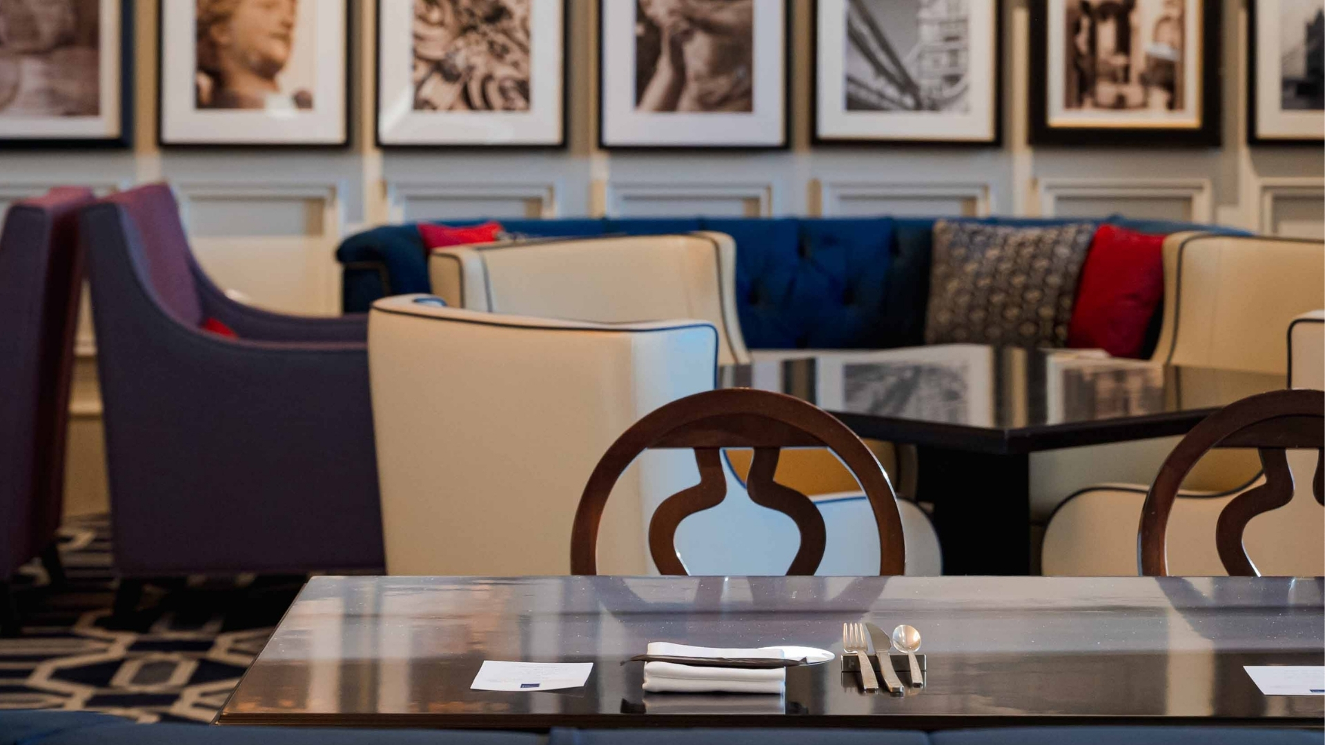 a table with silverware and a chair in a restaurant
