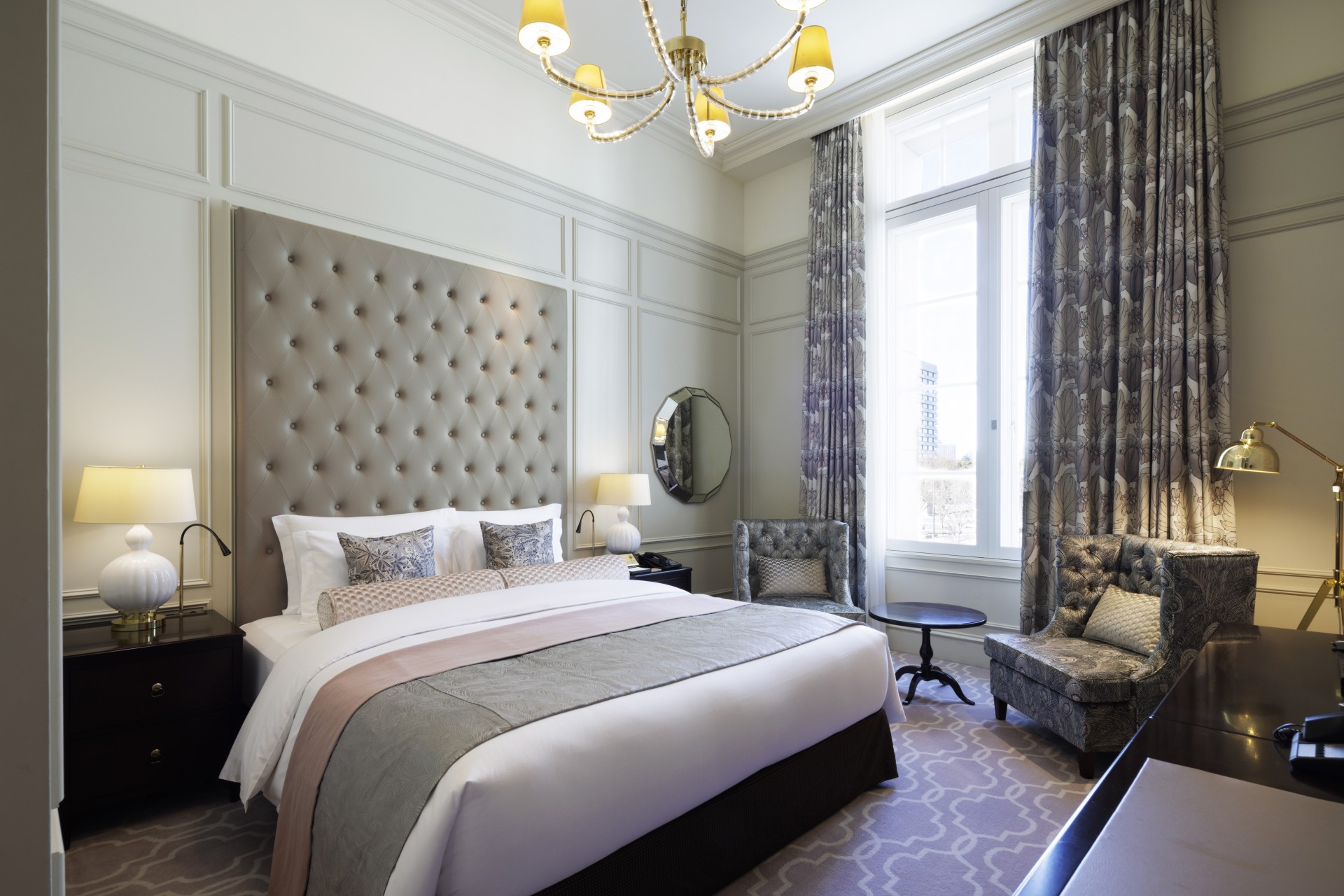 a bedroom with a bed and chairs