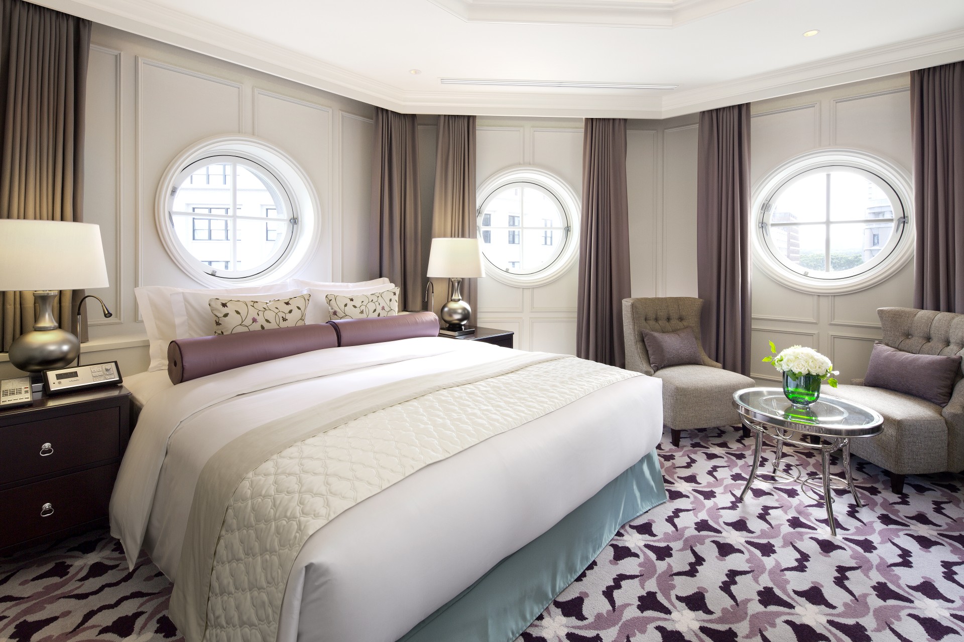 a room with round windows and a bed