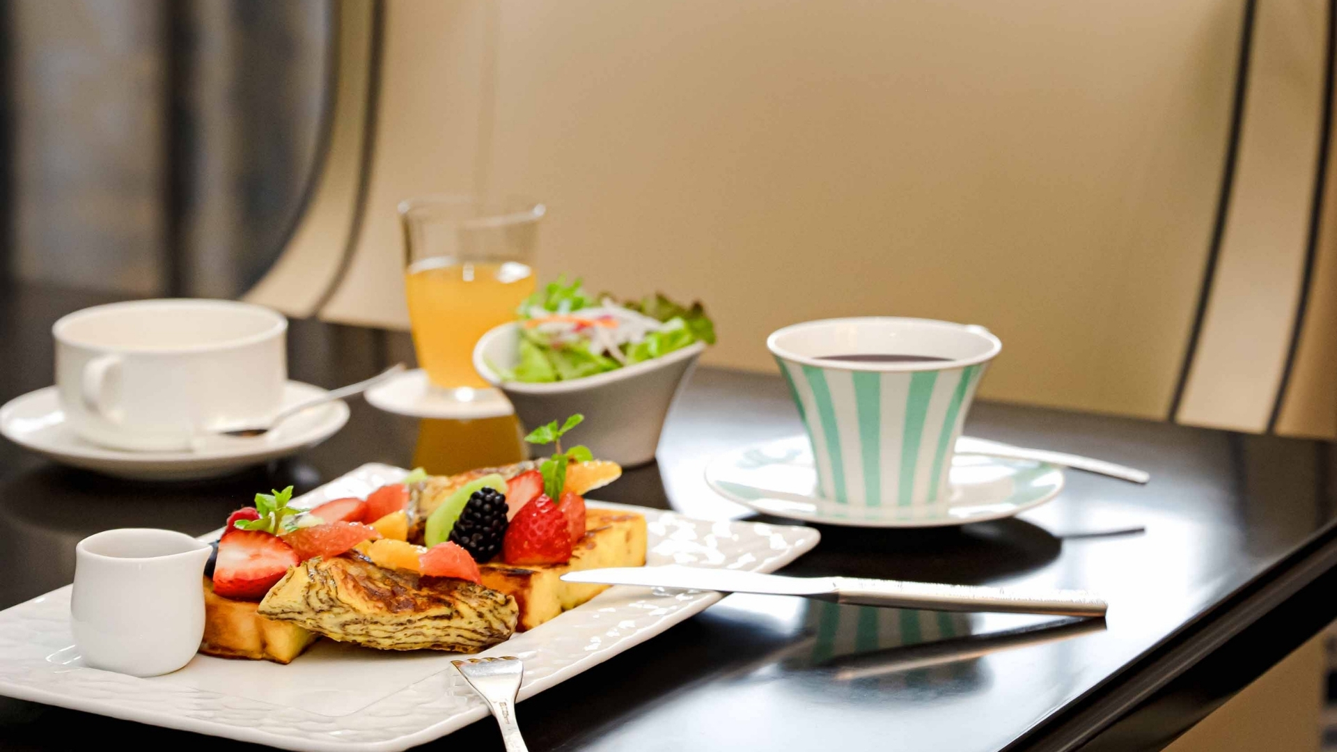 a plate of food and a cup of coffee