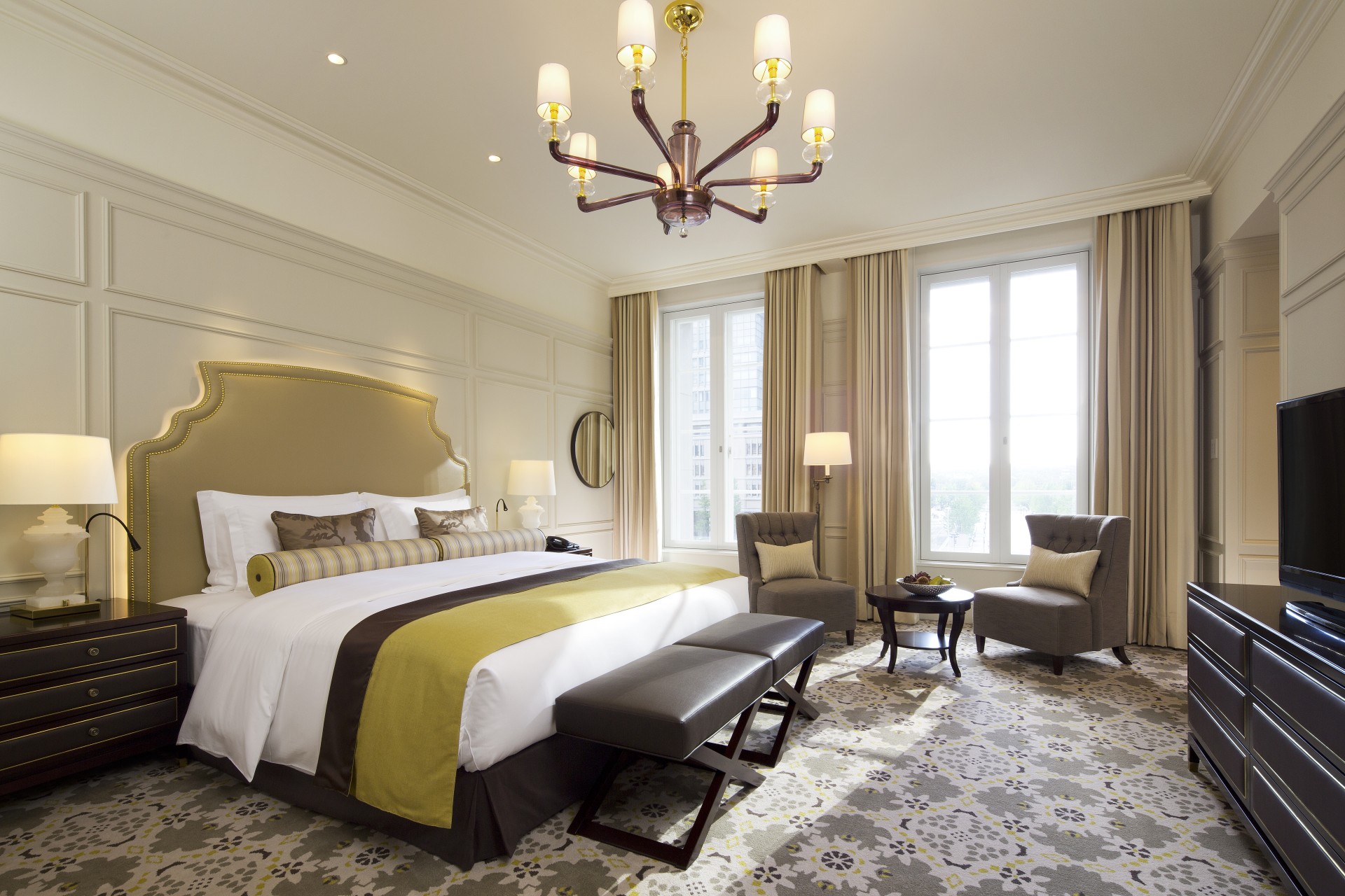 a room with a bed and chairs