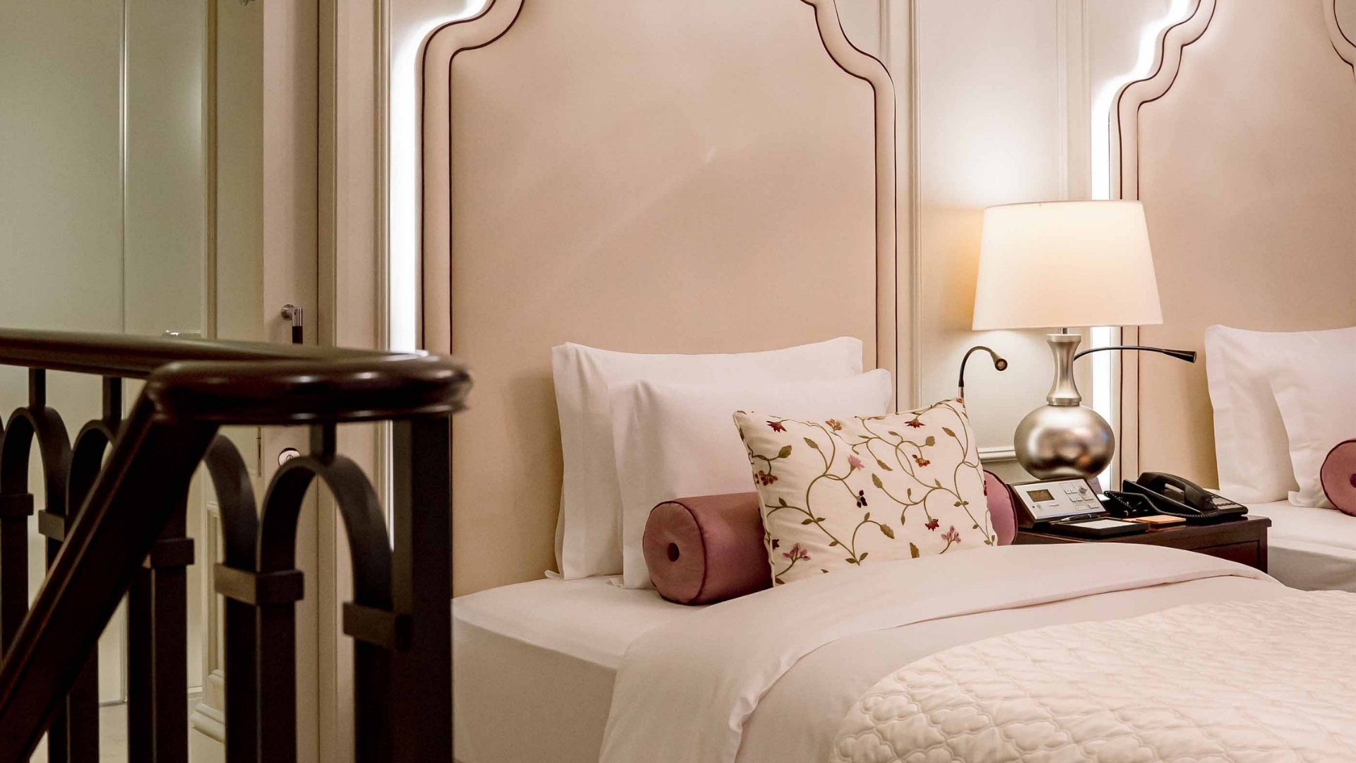 a bed with a pillow and a lamp