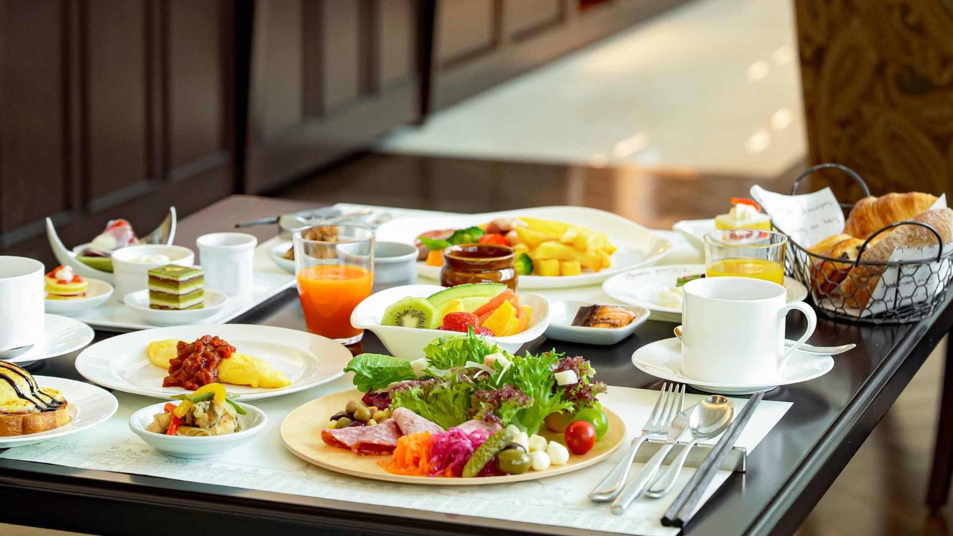 a table with plates of food and drinks
