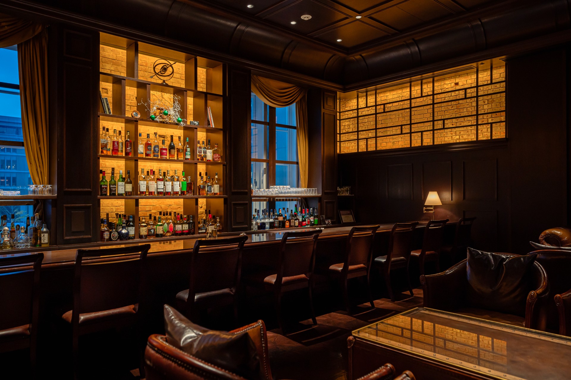 a room with a bar and chairs