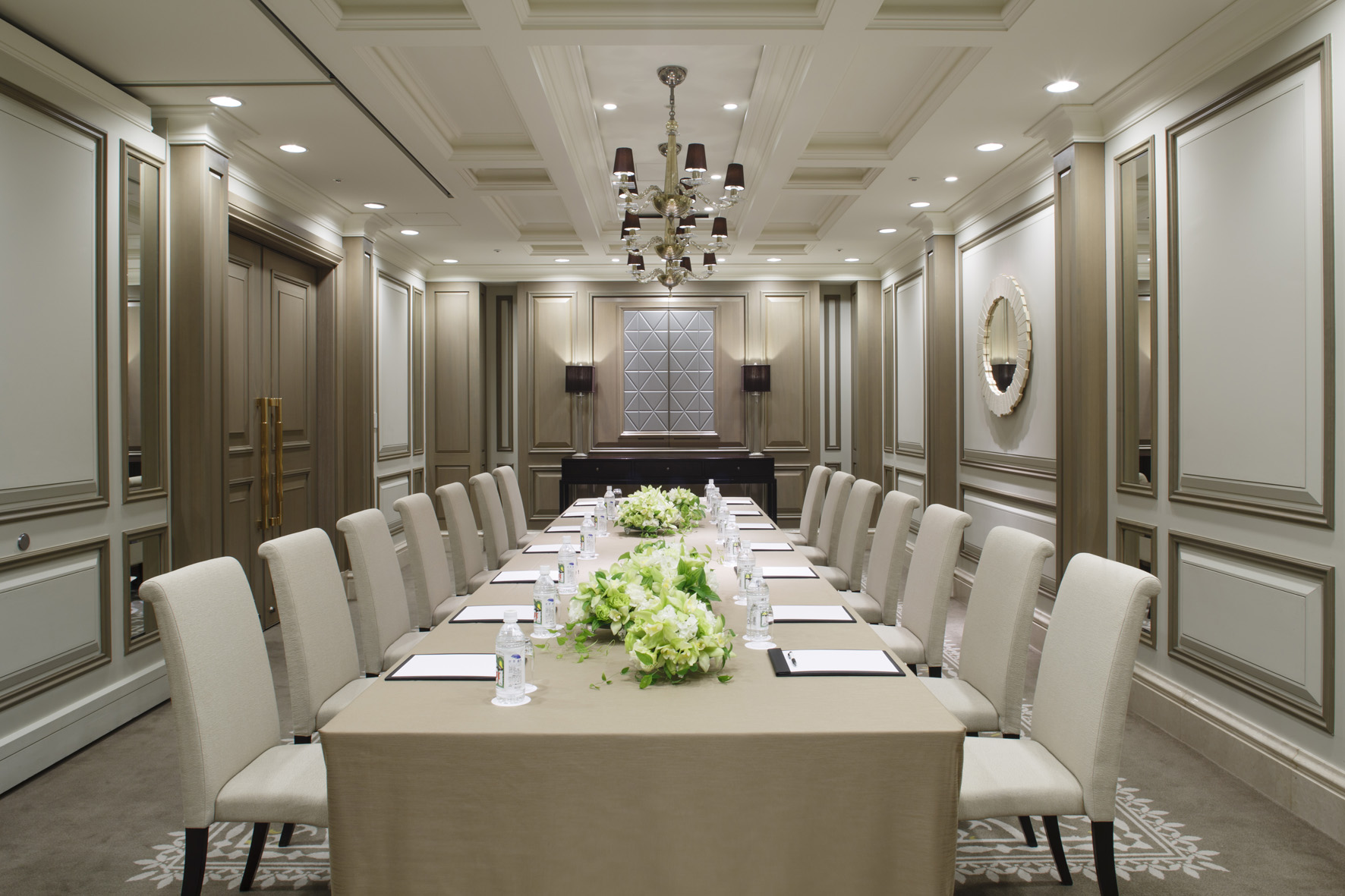 a long table with chairs and flowers on it