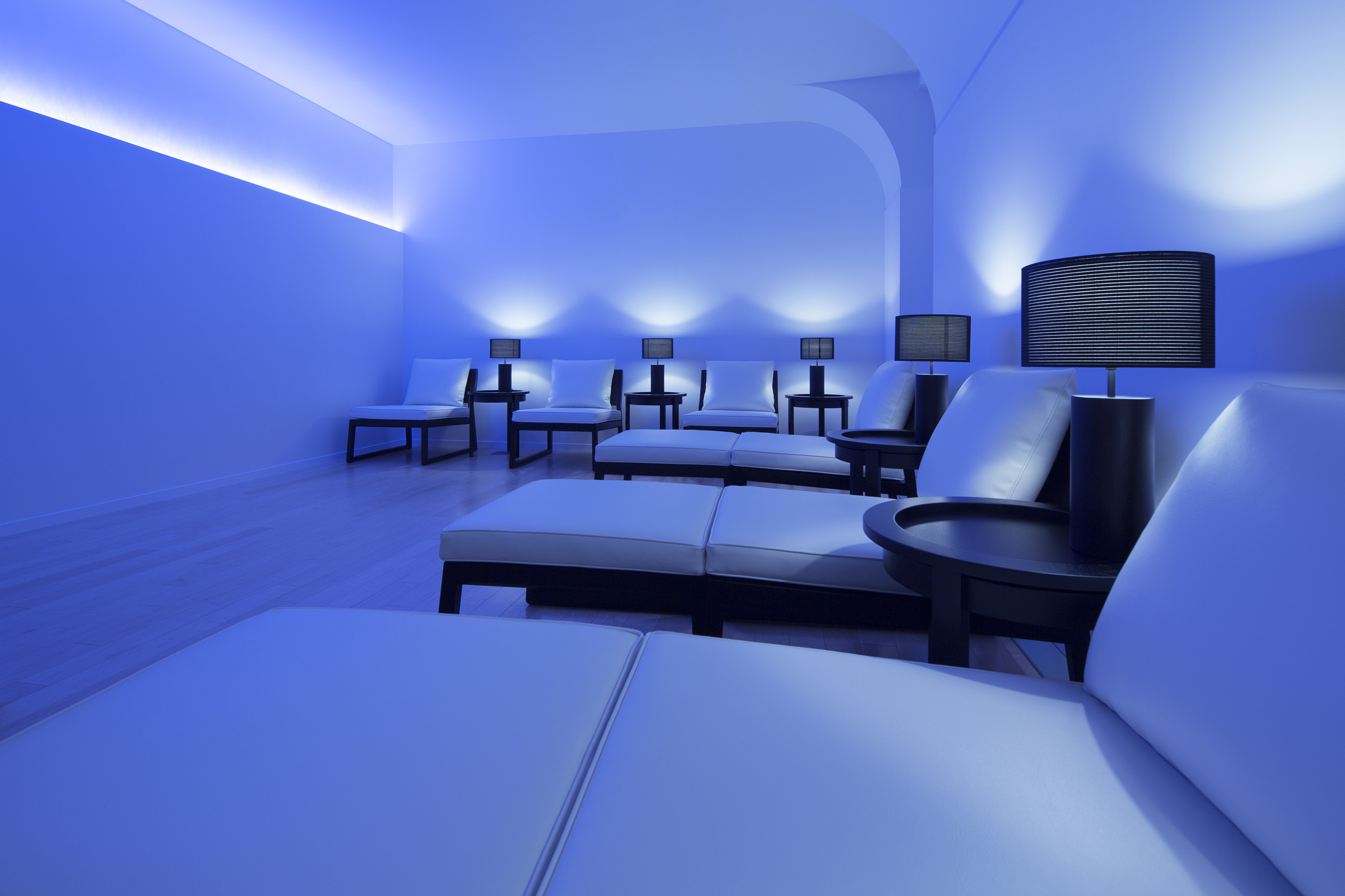 a room with white couches and tables