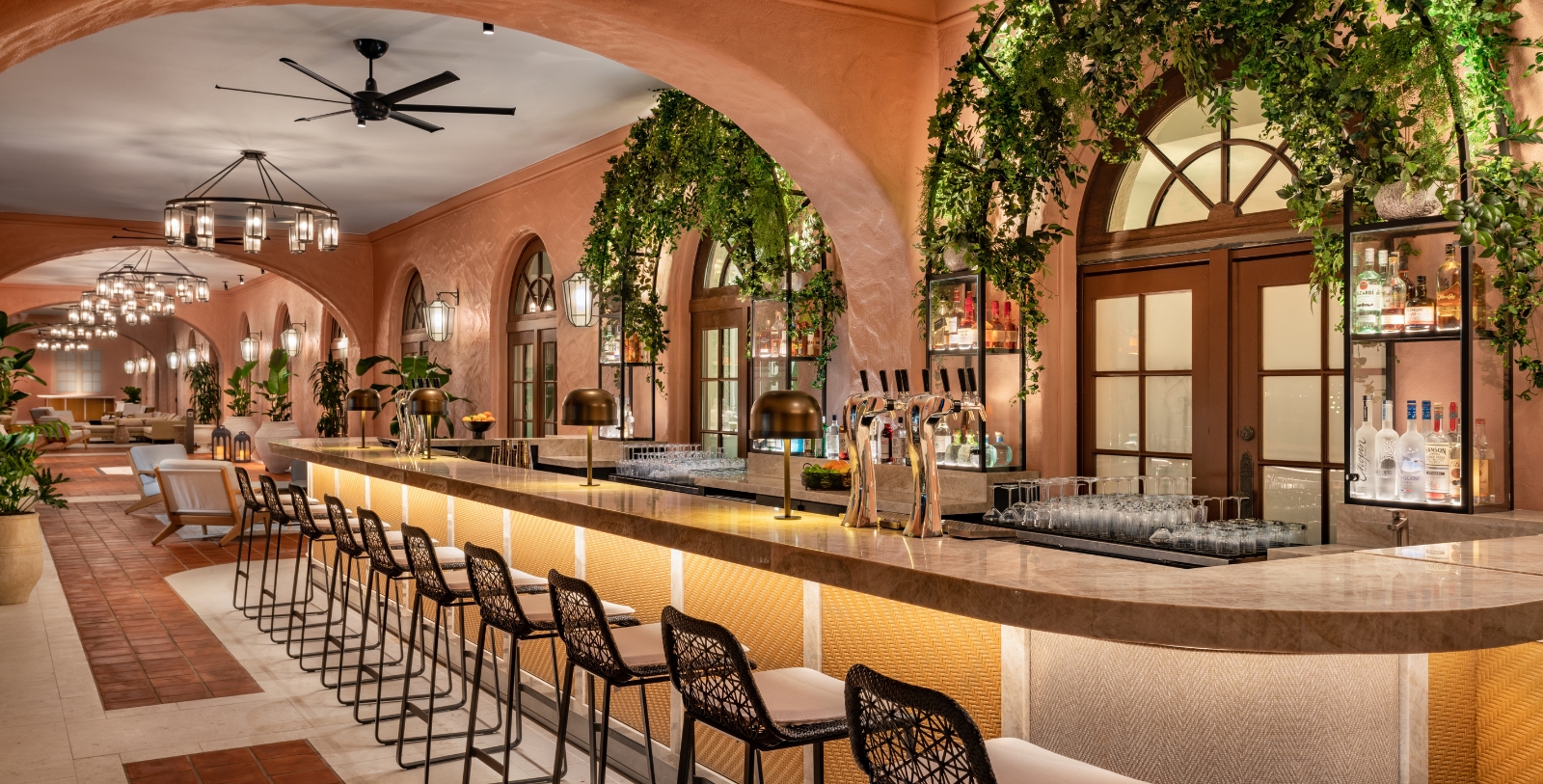 a bar with chairs and a fan