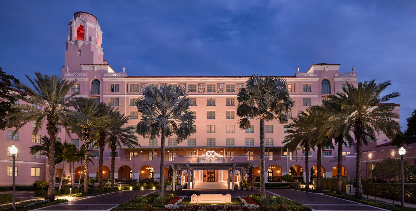 a large building with palm trees
