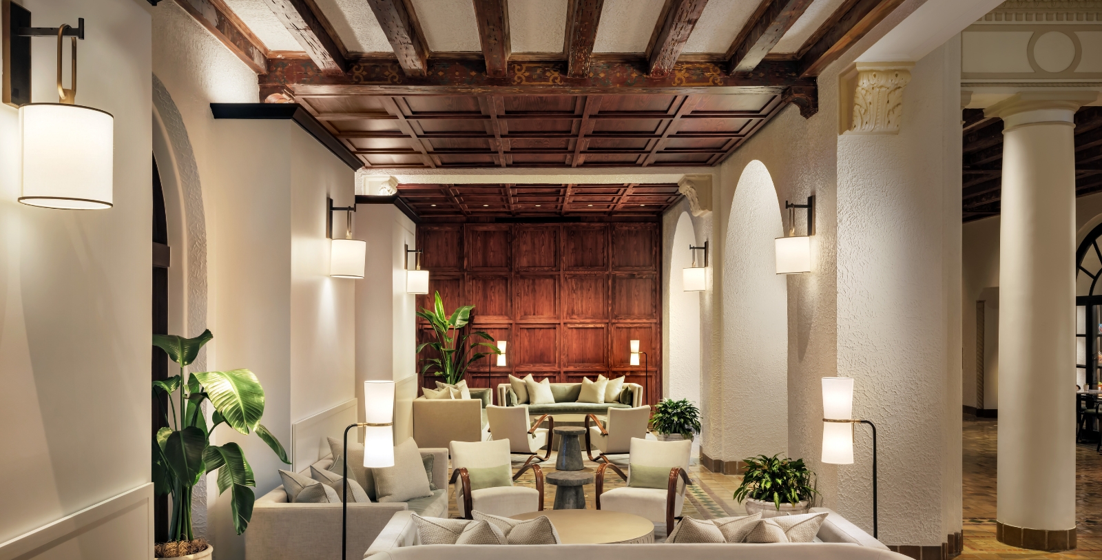 a room with a couch and chairs
