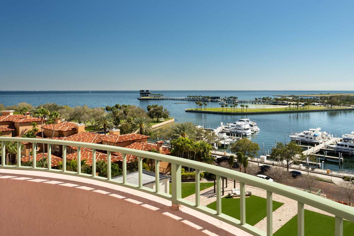 a balcony with a view of a marina and a dock