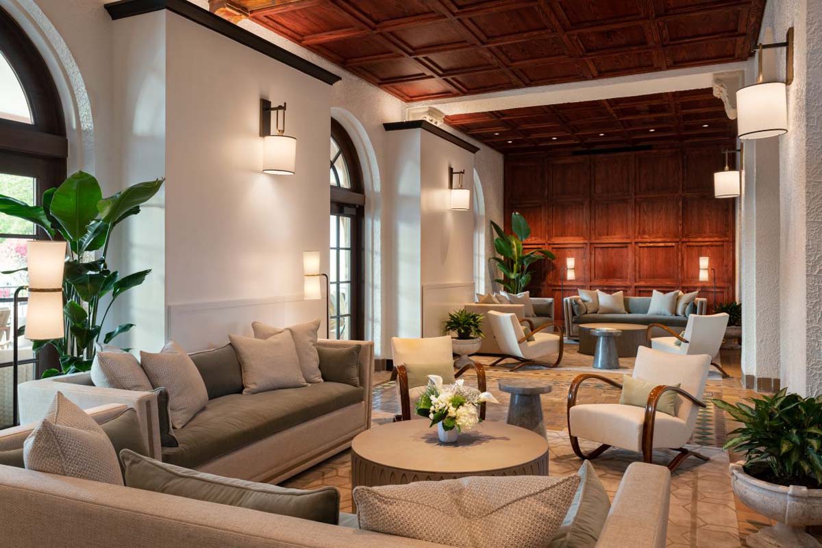 a room with a couch and chairs