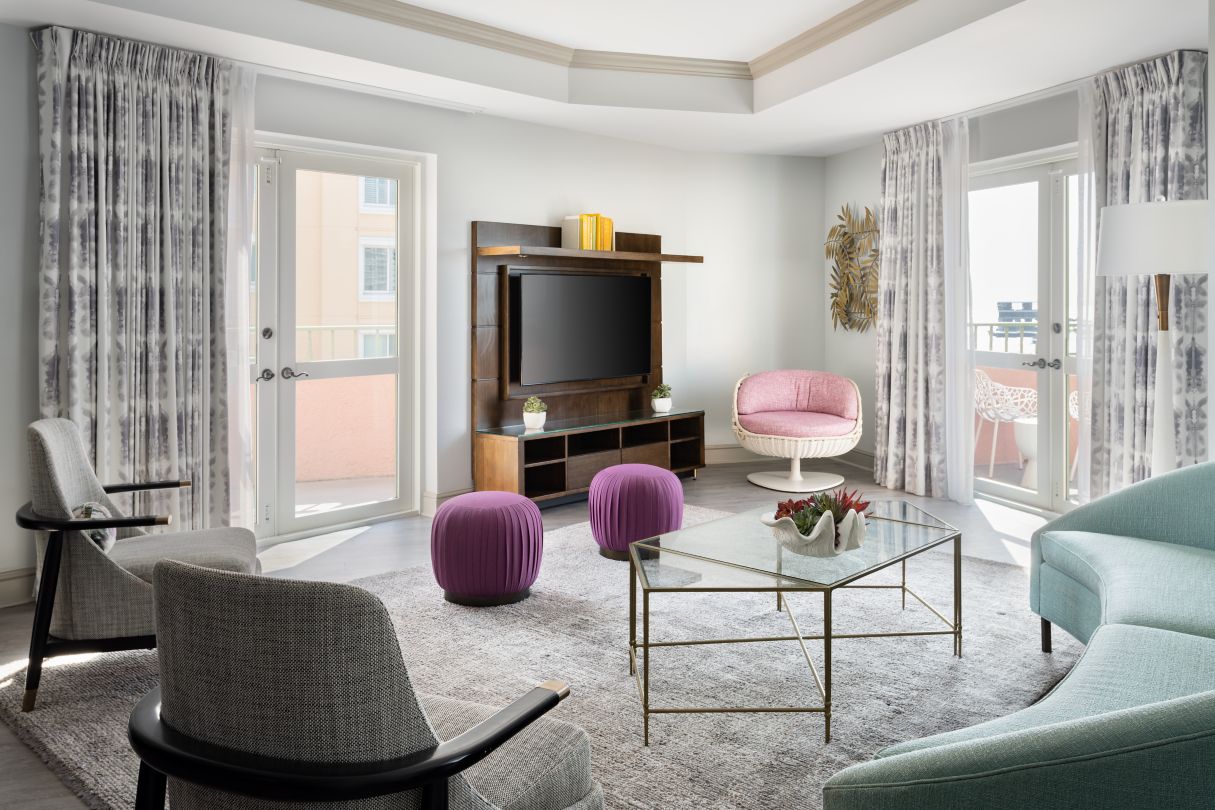 a living room with a television and chairs